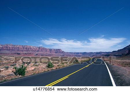 a Country Road Under a Blue Sky, Surrounded By a Flat Land But a Huge Rock Far Away View Large Photo Image Picture - a Country Road Under a Blue Sky, Surrounded By a Flat Land But a Huge Rock Far Away. Fotosearch