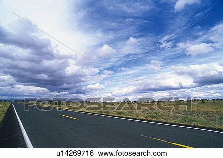 a Country Road Under a Blue Sky With a Lot of Clouds, Side View View Large Photo Image Stock Photograph - a Country Road Under a Blue Sky With a Lot of Clouds, Side View. Fotosearch
