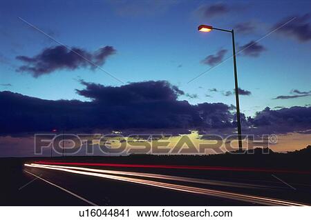 Stock Image -  a Highway Under the Sky By Sunset, Long Exposure. Fotosearch