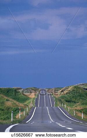 Stock Photo -  a Hilly Country Road, Surrounded By Green and Beige-colored Hills, High Angle View. Fotosearch