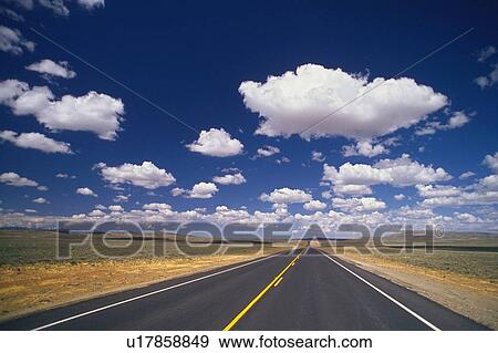 a Long Country Road Under a Blue Sky With a Lot of Clouds, Front View, Wyoming, USA View Large Photo Image Stock Photo - a Long Country Road Under a Blue Sky With a Lot of Clouds, Front View, Wyoming, USA. Fotosearch