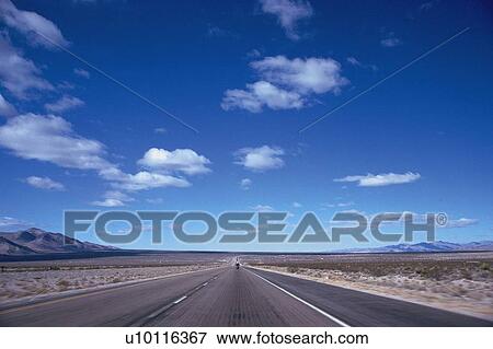a Long Road Through a Huge, Flat Land With Several Mountains Far Away, Front View View Large Photo Image Stock Photo - a Long Road Through a Huge, Flat Land With Several Mountains Far Away, Front View. Fotosearch