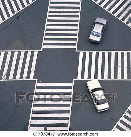 Stock Photo - Several Funny Arranged Zebra Crossings With Two Cars in the Image, High Angle view. Fotosearch
