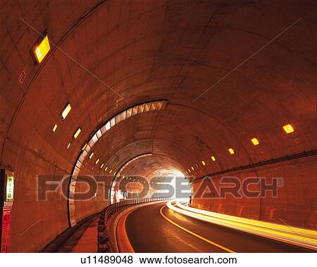 Stock Photo -  the Daisetsu Tunnel, the Outside Light Visible at the End, Long Exposure, Hokkaido Prefecture, Japan. Fotosearch