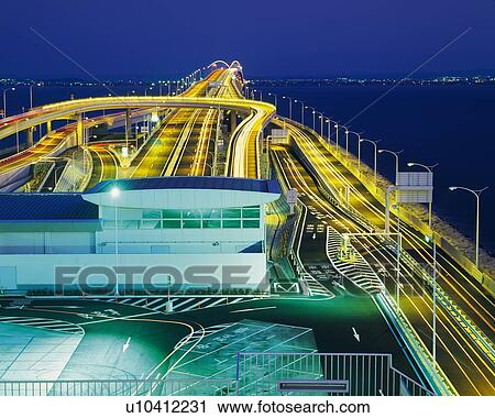 Stock Image -  the Tokyo Wan Aqua-line, Surrounded By the Ocean and an Illuminated City, High Angle View, Long Exposure, Chiba Prefecture, Japan. Fotosearch