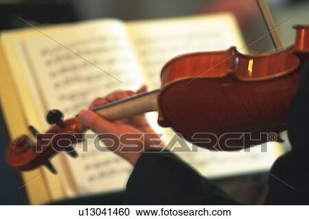 Stock Image - Person play a violin. Fotosearch