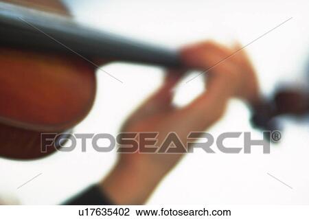 Stock Image - Person play a violin. Fotosearch
