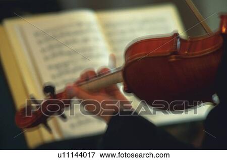 Stock Photo - Person play a violin. Fotosearch