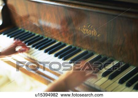Stock Image - Person play the piano. Fotosearch