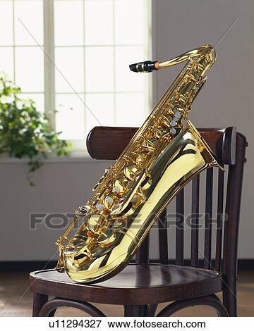 Stock Photo - Saxophone on the chair, close up. Fotosearch