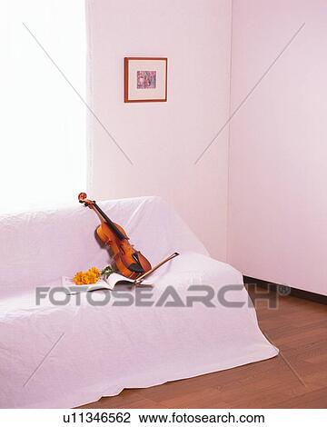 Violin on the sofa View Large Photo Image Stock Image - Violin on the sofa. Fotosearch