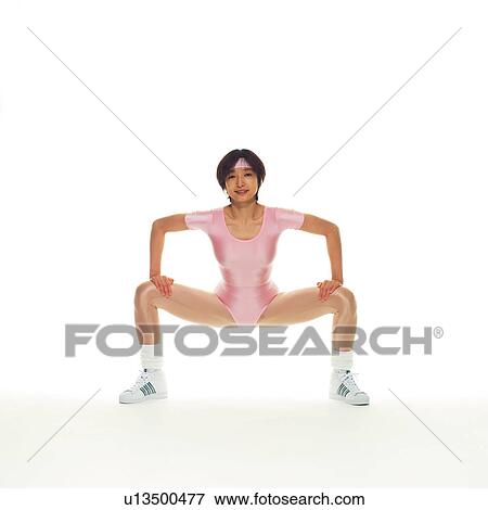 Stock Photo - A woman in Leotard exercising, Front View, Copy Space. Fotosearch