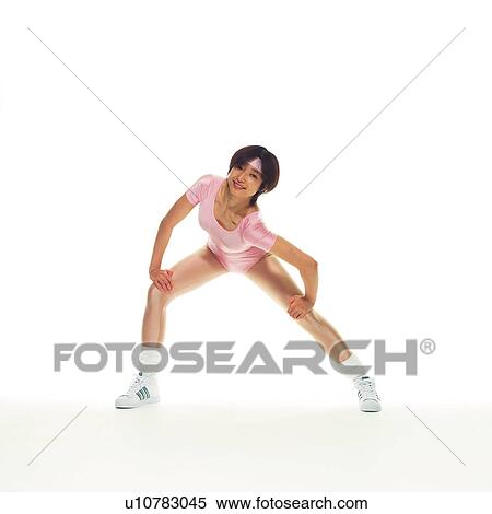 Stock Photography - A woman in Leotard exercising, Front View, Copy Space. Fotosearch