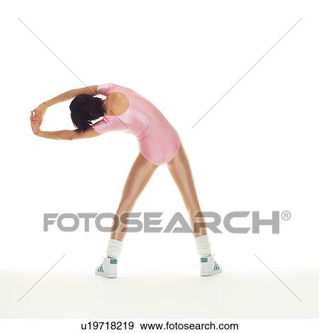 Stock Photo - A woman in Leotard exercising, Rear View, Copy Space. Fotosearch
