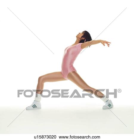 Stock Image - A woman in Leotard exercising, Side View, Copy Space. Fotosearch