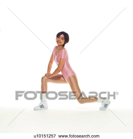 Stock Photo - A woman in Leotard exercising, Side View, Copy Space. Fotosearch