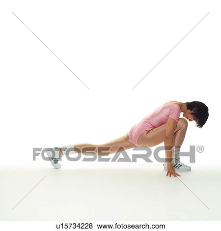 Stock Photo - A woman in Leotard exercising, Side View, Copy Space. Fotosearch
