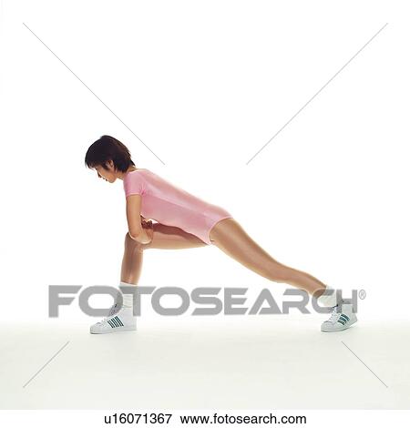 Stock Photo - A woman in Leotard exercising, Side View, Copy Space. Fotosearch