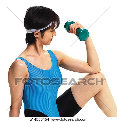 Picture - A woman in Leotard exercising with a dumbbell, Side View. Fotosearch