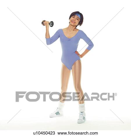Stock Image - A woman in Leotard exercising with a dumbbell, Front View, Copy Space. Fotosearch