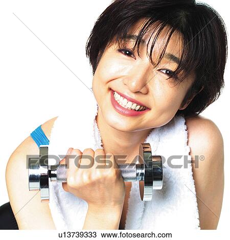 Stock Image - A woman in Leotard exercising with a dumbbell, Front View. Fotosearch
