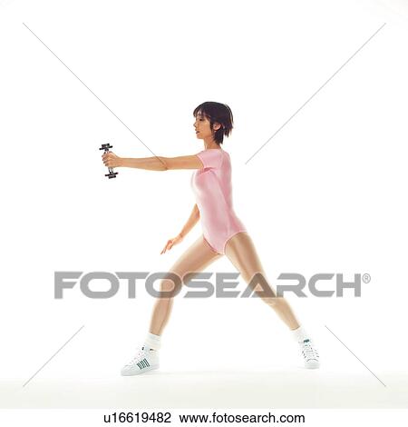 Stock Image - A woman in Leotard exercising with a dumbbell, Side View, Copy Space. Fotosearch