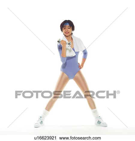 Stock Image - A woman in Leotard exercising with a dumbbell, Front View, Copy Space. Fotosearch