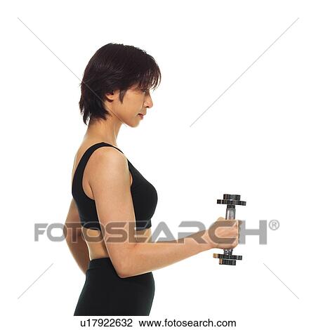 Stock Image - A woman in Leotard exercising with a dumbbell, Side View, Copy Space. Fotosearch