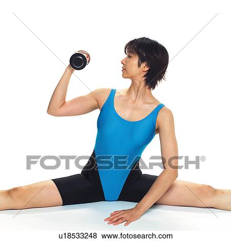 Stock Photo - A woman in Leotard exercising with a dumbbell, Side View, Front View. Fotosearch