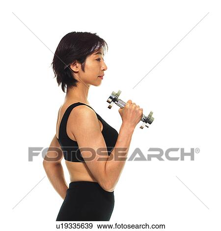 Stock Photo - A woman in Leotard exercising with a dumbbell, Side View, Copy Space. Fotosearch