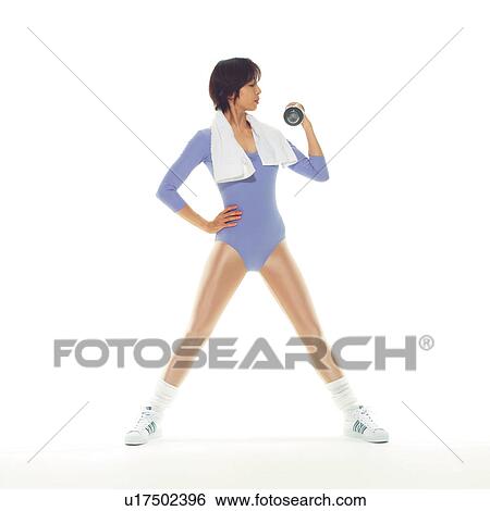 Stock Photograph - A woman in Leotard exercising with a dumbbell, Side View, Copy Space. Fotosearch