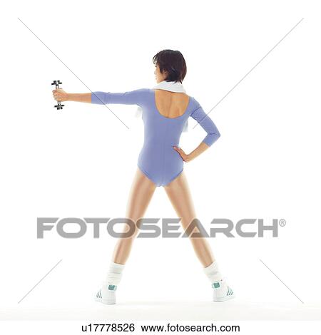 Stock Photograph - A woman in Leotard exercising with a dumbbell, Rear View, Copy Space. Fotosearch