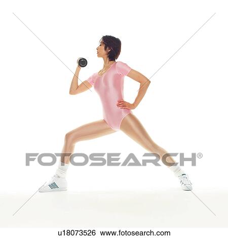 Stock Photograph - A woman in Leotard exercising with a dumbbell, Side View, Copy Space. Fotosearch