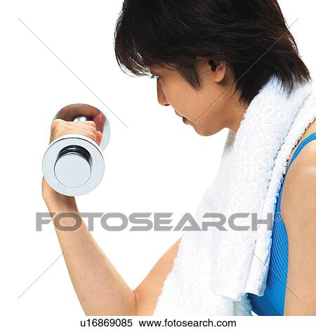 Stock Photography - A woman in Leotard exercising with a dumbbell, Side View. Fotosearch
