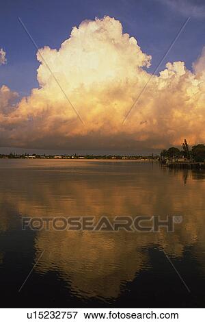 a Huge Cloud, Partly Red From the Setting Sun, Water Reflecting It, Front View, Bahamas, North America View Large Photo Image Stock Photo - a Huge Cloud, Partly Red From the Setting Sun, Water Reflecting It, Front View, Bahamas, North America. Fotosearch