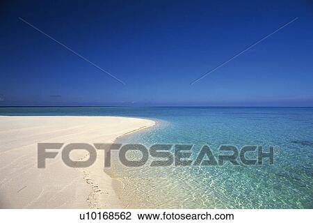 Stock Image -  a Maldivian Beach With Its White Sand and Clear Water Under the Blue Sky, Maldives, Micronesia. Fotosearch