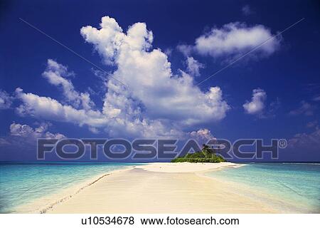 Stock Photo -  a Maldivian Beach With the Ocean on Both Sides Under a Blue Sky, Front View, Maldives, Micronesia. Fotosearch