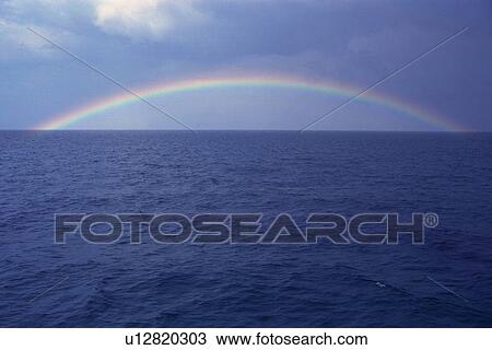 Stock Image -  a Rainbow Over the Deep Blue Ocean, Front View, Bahamas, North America. Fotosearch