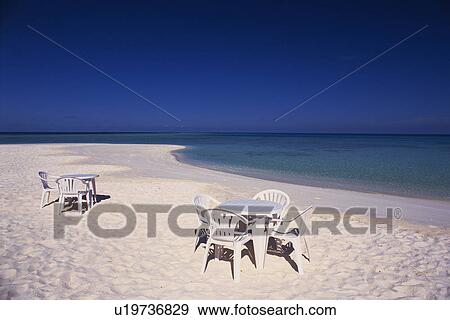 Stock Photo -  a Several White Chairs and Tables at the Beach on the Sand, High Angle View, Maldives, Micronesia. Fotosearch