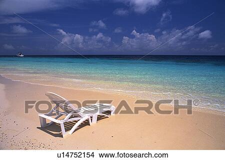 a White Sunlounger at the Beach Near the Ocean Water High Angle View, Maldives, Micronesia View Large Photo Image Picture - a White Sunlounger at the Beach Near the Ocean Water High Angle View, Maldives, Micronesia. Fotosearch