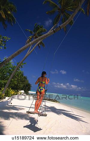 a Woman Standing on a Swing By the Beach Under a Blue Sky, Side View, Maldives, Micronesia View Large Photo Image Picture - a Woman Standing on a Swing By the Beach Under a Blue Sky, Side View, Maldives, Micronesia. Fotosearch