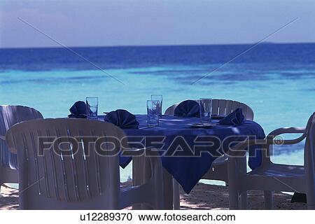 Several Chairs and a Setted Table Right Next to the Ocean water, Differential Focus, Maldives, Micronesia View Large Photo Image Stock Image - Several Chairs and a Setted Table Right Next to the Ocean water, Differential Focus, Maldives, Micronesia. Fotosearch