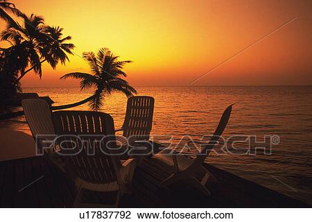 Several Chairs Standing Near the Ocean By Sunset, High Angle View, Maldives, Micronesia View Large Photo Image Stock Image - Several Chairs Standing Near the Ocean By Sunset, High Angle View, Maldives, Micronesia. Fotosearch