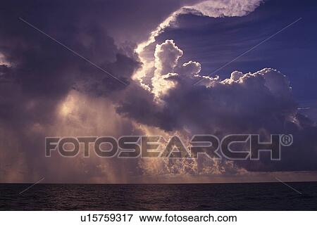 Several Clouds Over the Ocean, Partly Shined On by the Sun, Bahamas North America View Large Photo Image Stock Photo - Several Clouds Over the Ocean, Partly Shined On by the Sun, Bahamas North America. Fotosearch