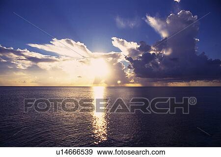 the Deep Blue Ocean Reflecting the Lights of the Setting Sun Under a Blue Sky, Front View, Bahamas, North America View Large Photo Image Stock Photo - the Deep Blue Ocean Reflecting the Lights of the Setting Sun Under a Blue Sky, Front View, Bahamas, North America. Fotosearch