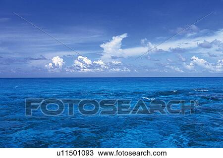 the Deep Blue Ocean Under a Blue Sky and Some Clouds, Maldives, Micronesia View Large Photo Image Stock Image - the Deep Blue Ocean Under a Blue Sky and Some Clouds, Maldives, Micronesia. Fotosearch