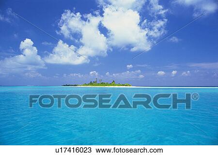 Stock Image -  The Republic of Maldives Under a Deep Blue Sky, Surrounded By Clear, Light Blue-colored Water, Far View, Maldives, Micronesia. Fotosearch