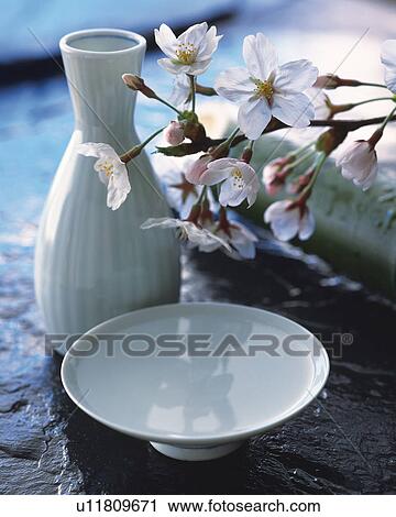 Stock Image - Cherry blossom and sake cup. Fotosearch