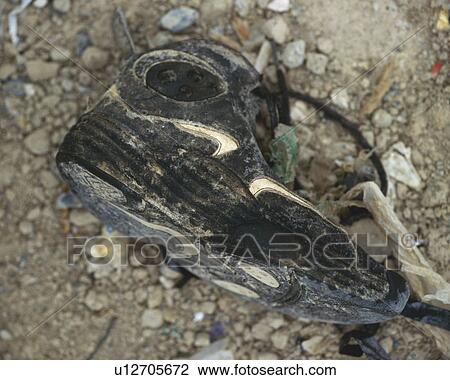 Stock Image - Close up of black sneaker abandoned on ground, high angle view. Fotosearch