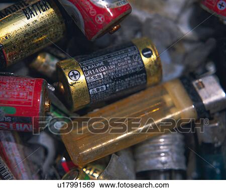 Stock Photo - Closed up of used batteries and lighters, high angle view, Full Frame. Fotosearch